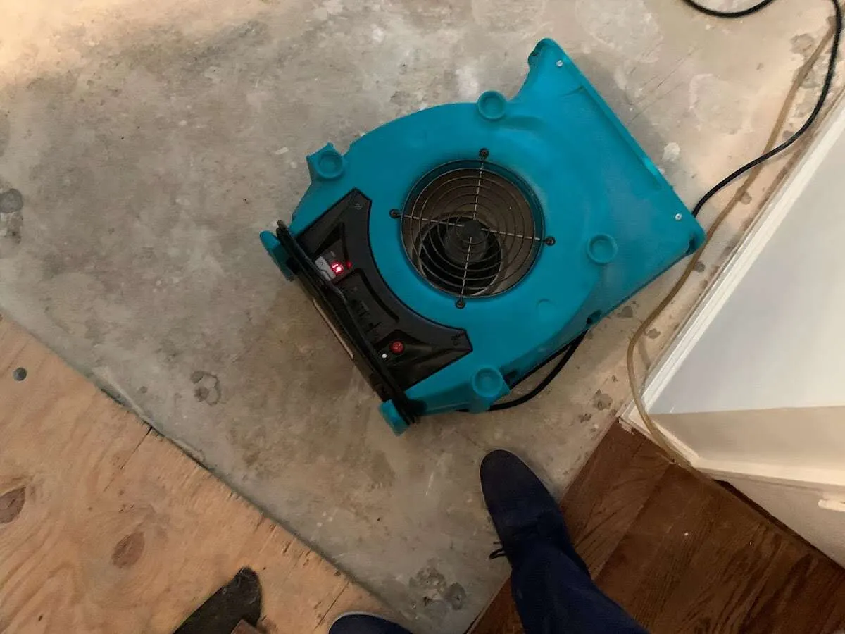 Air mover drying subfloor during Leak Detection & Repair in Harpswell